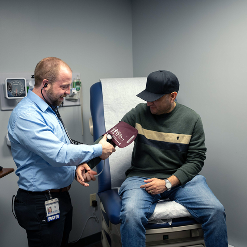 Primary care provider talking with a patient during an exam at InterCommunity Health Care.